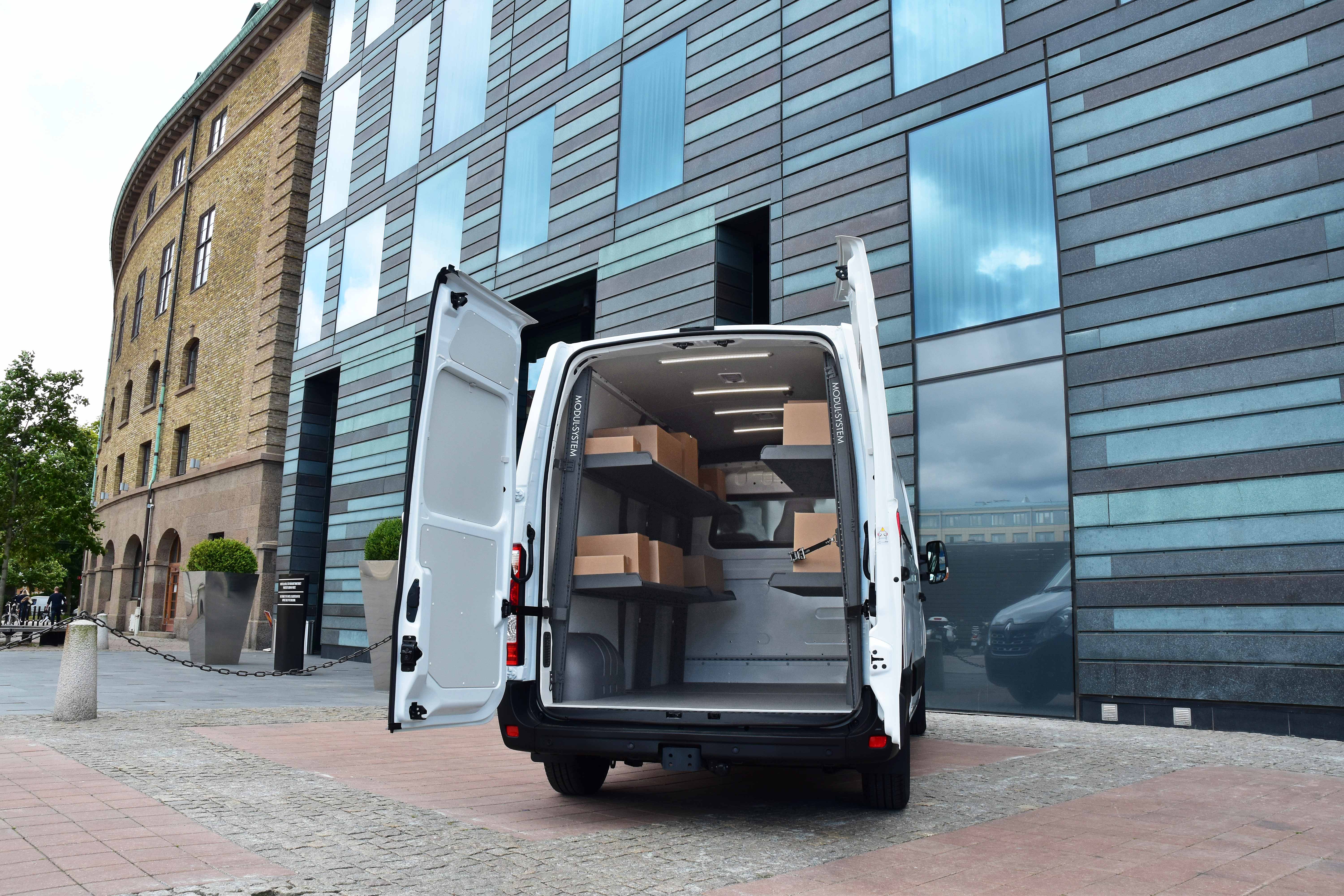 Van fitted out with modul-express van shelving holding delivery boxes