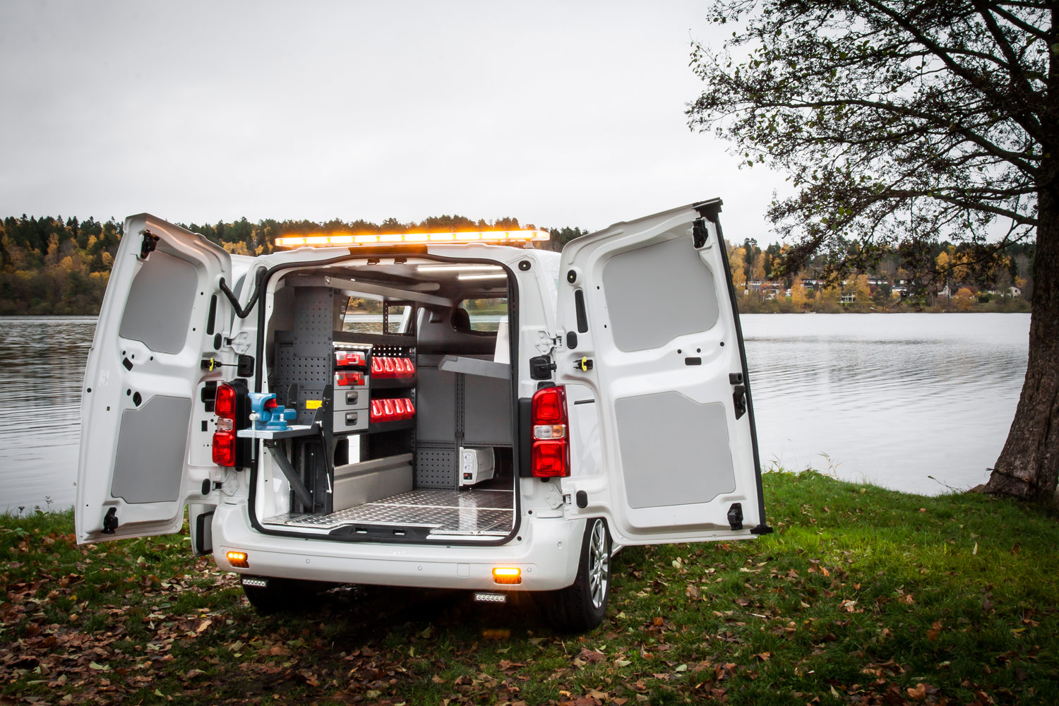 Worker's van fitted out with modul-system van racking by a river